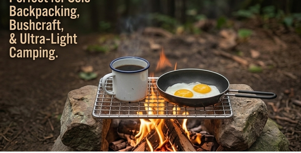 A camping cook setup outdoors over a fire, with a metal rack holding a white mug and a black skillet containing two sunny-side-up eggs. Text on the left reads, 'Perfect for Solo Backpacking, Bushcraft, & Ultra-Light Camping.